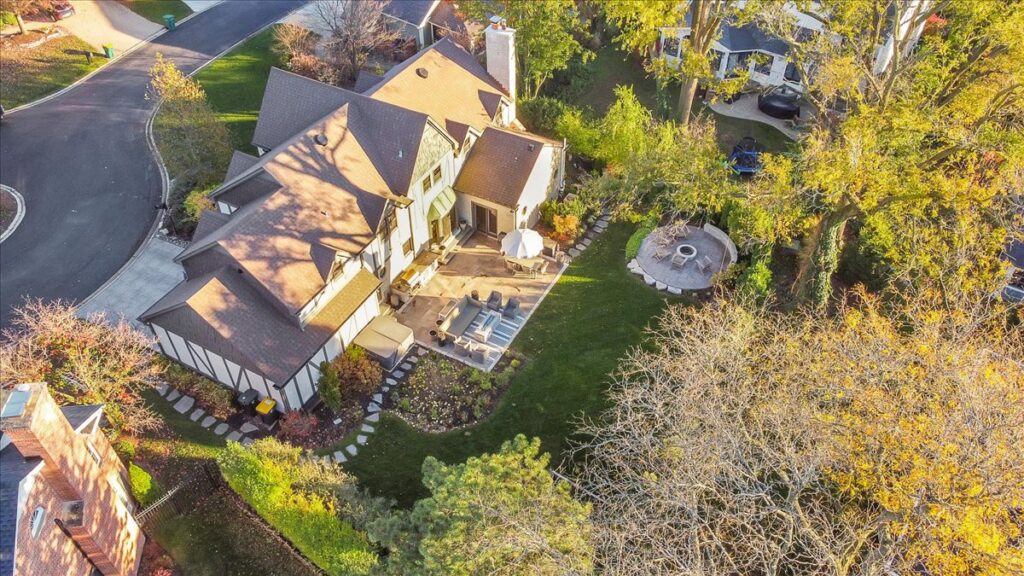 Aerial drone photo of a home, backyard patio and fire pit